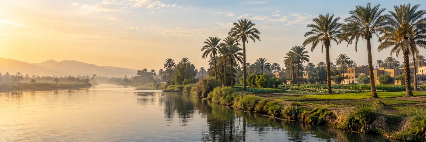 The Nile at Beni Suef with date palms, cultivated fields and a village on the far bank